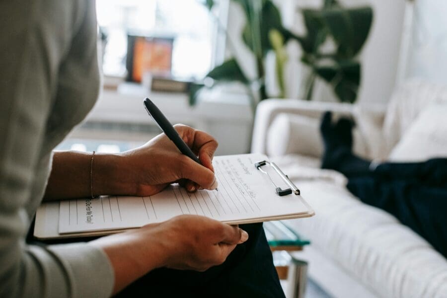 A women with a clipboard interviewing a client